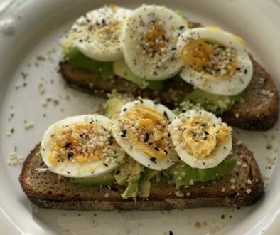 Avocado toast and eggs on bread from multigrain box